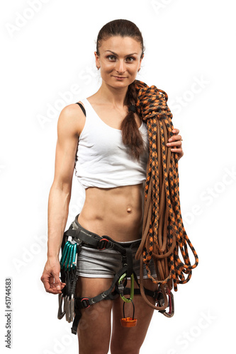 Photo: Young female rock climber wearing safety harness and with rope Young female rock climber wearing safety harness and with rope