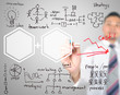 Photo: Business man drawing cost reduction Business man drawing cost reduction