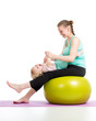mother doing gymnastics with baby  on fitness ball
