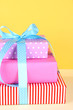 Gift box tied with a ribbon on a colored background
