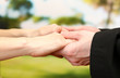 Priest holding woman hands, on green background