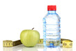 Bottle of water, apple and measuring tape isolated on white