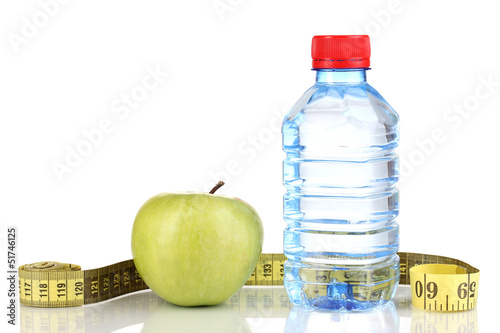 Photo: Bottle of water, apple and measuring tape isolated on white Bottle of water, apple and measuring tape isolated on white