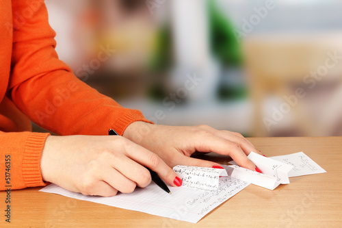 Photo: Write off exam on wooden table on room background Write off exam on wooden table on room background