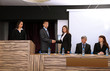 Business people at tribune in conference room