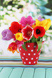 Beautiful tulips in bouquet on table on bright background