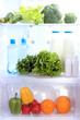 Open refrigerator with vegetarian food