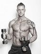 Sexy guy is holding dumbbells