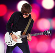 Young punk is playing on his cool guitar