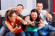 Friends sitting in front of game console box