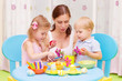 Mother with kids paint Easter eggs