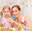 Mother with daughter painted Easter eggs