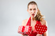 Foto: Woman opening the gift and is disappointed Woman opening the gift and is disappointed