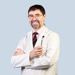 Photo: Portrait of happy middle-aged dentist on a pale background, wear Portrait of happy middle-aged dentist on a pale background, wear