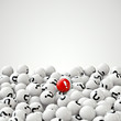 many gray balls with question marks, and one red