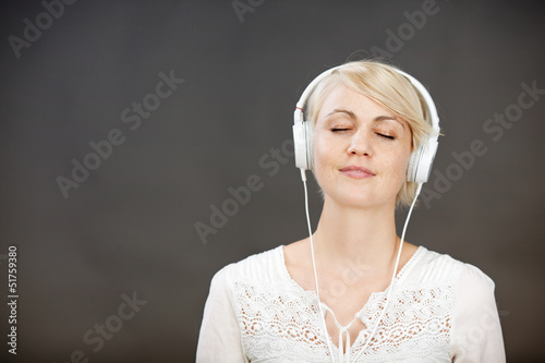 Photo: frau hört musik mit geschlossenen augen frau hört musik mit geschlossenen augen