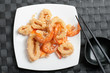 plate with fried mixed seafood with chopsticks