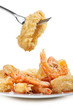 plate of fried fish on white background with fork