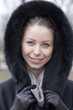 Portrait of a young woman on the background of a winter city