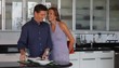 Caucasian woman surprising husband with gift