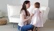 Caucasian mother cleaning nose of daughter