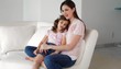 Caucasian mother rocking daughter