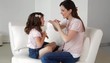 Caucasian mother and daughter playing spider
