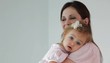 Caucasian mother holding daughter