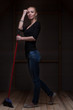 Photo: Portrait of young blond woman with broom in full length Portrait of young blond woman with broom in full length