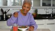 Senior African American woman eating salad
