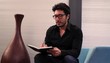 Hispanic man in creative space drawing in sketchbook