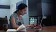 Japanese woman at home typing on laptop