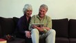 Senior Caucasian couple at home sharing digital tablet