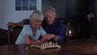 Senior Caucasian couple at home playing chess