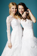 blonde and brunette bride on blue background