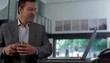Hispanic businessman typing at laptop then turning to think