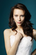 beautiful girl in wedding dress on blue background