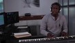 Young man at music station playing electronic keyboard