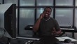 Young man at workstation conversing on cell phone
