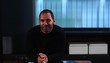 Mature man sitting at desk with digital tablet