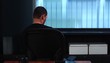 Mature man at desk spinning in chair holding file folders and taking notes