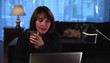 Relaxed woman at home enjoying laptop while dog looks on