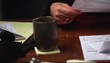 Pan to woman's hands sorting through bills
