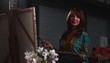 Portrait of artist in studio painting flowers on canvas 