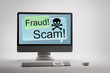 Computer displaying internet fraud and scam warning on screen