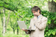 Portrait of happy middle-aged businessman holding notebook and t