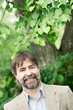 Portrait of happy middle-aged businessman looking at camera and