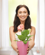 lovely housewife with flower in pot