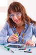 Woman fixing computer parts