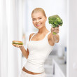 woman with broccoli and hamburger